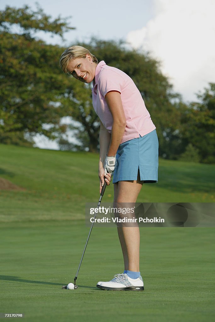 Mature woman playing golf