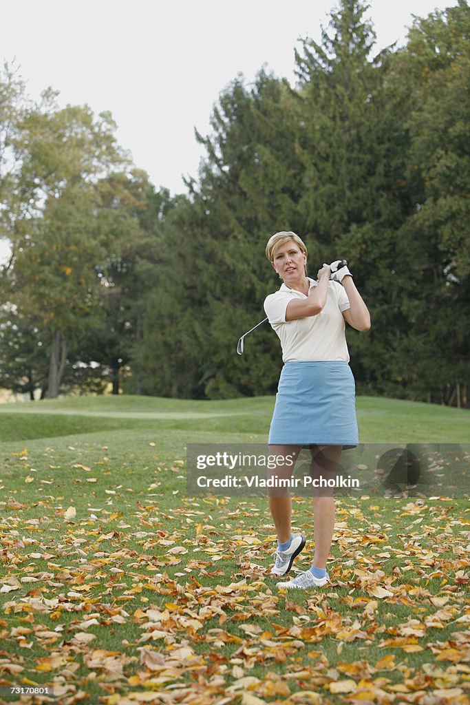 Mature woman playing golf