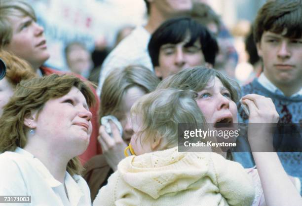 Weeping families watch from the quayside as the Cunard liner QE2 carries British troops from Southampton during the Falklands War, 12th May 1982.