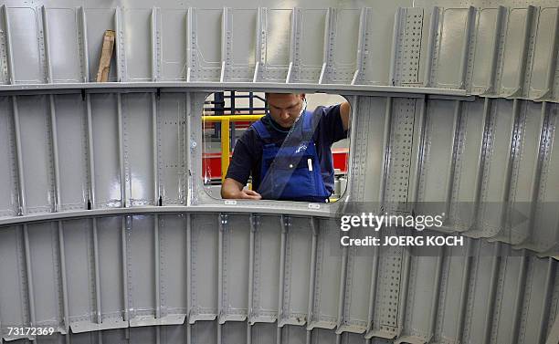 An employee of the European aerospace giant EADS works on the assembling of aircraft components 01 February 2007 at the company's plant in Augsburg,...