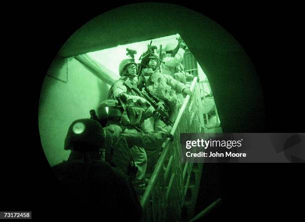 Marines storm a house while on a search operation for insurgents in the early hours of February 1, 2007 in Ramadi in Iraq's Anbar province. American...