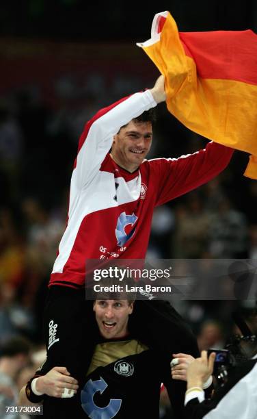 Oliver Roggisch of Germany lifts Henning Fritz on his sholders during the IHF World Championship semi final game between Germany and France at the...