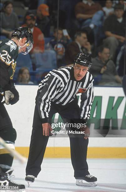 American ice hockey linesman Pat Dapuzzo prepares to drop the puck during a game involving the Dallas Stars, October 2001.