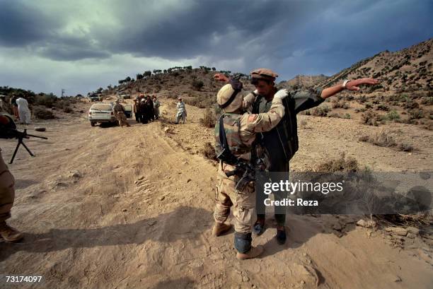 At this check-point of the Pashtun tribal zone of Waziristan, identity checks and palpations are improvised on July, 2004 in Afghanistan.