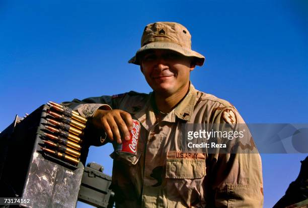 American soldier of the alpha company, Second Battalion, 27th Infantry Regiment drinking a Coke on July, 2004 in Afghanistan.