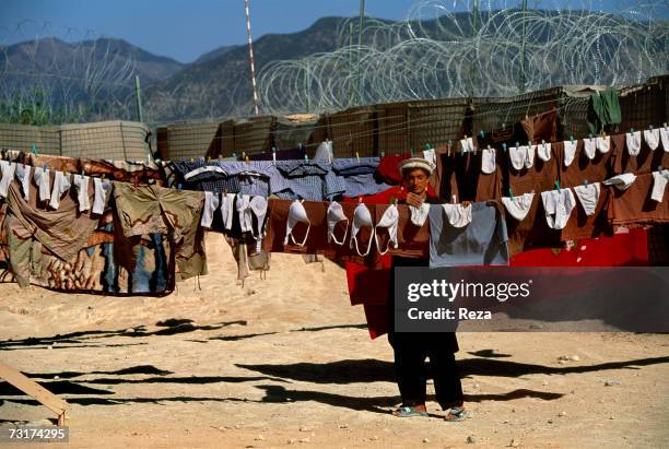 Young Afghan is spreading out the laundry of the soldiers in the Pashtun tribal zone of Waziristan on July, 2004 in Afghanistan.