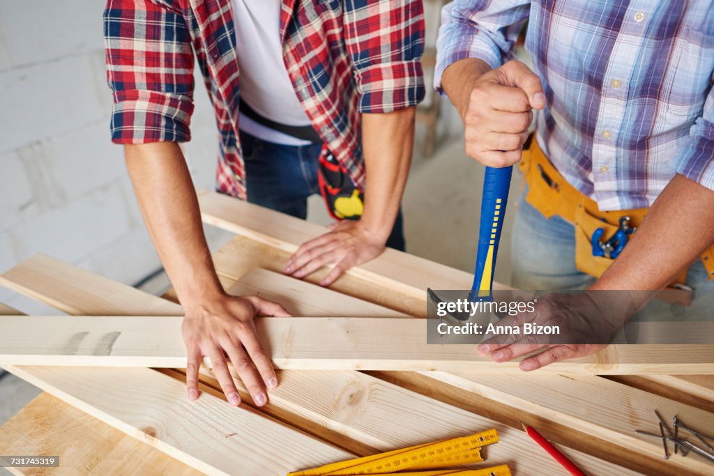 Carpenters removing nails from wood. Debica, Poland