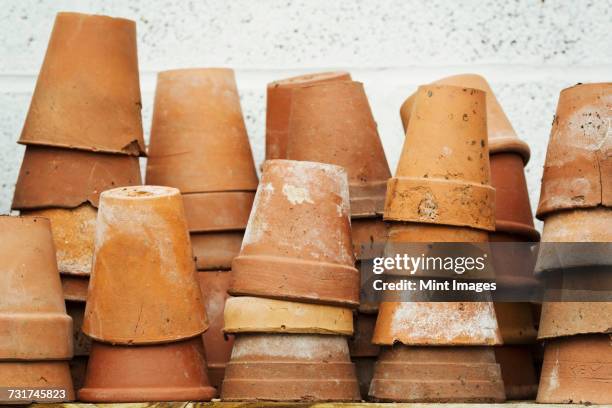 close up of stacks of terracotta plant pots. - flower pot stock pictures, royalty-free photos & images