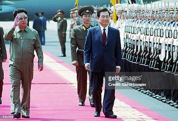 North Korean leader Kim Jong Il, left, and South Korean President Kim Dae-jung walk along a red carpet June 13, 2000 at the Sunan International...