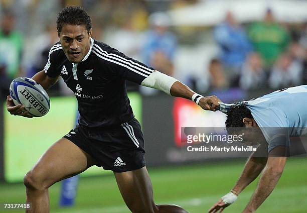 Afeleke Pelenise of New Zealand fends off Santiargo Gomez Cora of Argentina during the IRB New Zealand Sevens match between New Zealand and Argentina...