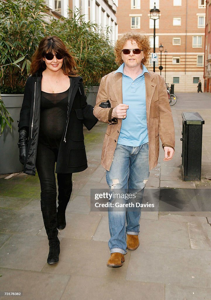 Musician Mick Hucknall and girlfriend Gabriella Wesberry walk in