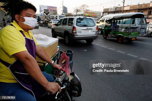 Thai food vender merges into rush hour traffic during rush hour on February 2, 2007 in Bangkok, Thailand. A report by the Intergovernmental Panel on...