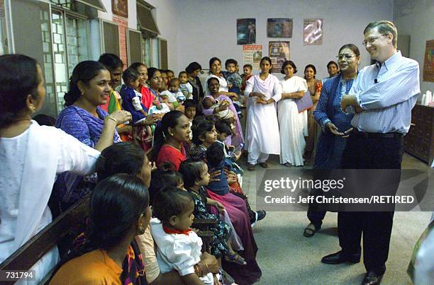 Microsoft chairman Bill Gates, Co-Founder of the Bill & Melinda Gates Foundation, talks to a group of mothers and their children September 14, 2000...