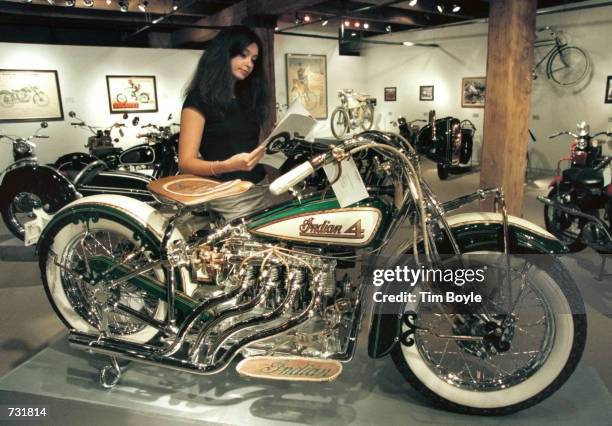 Marcia Taziola looks over a catalog featuring this 1930 Indian four-cylinder motorcycle up for auction Sept. 13, 2000 at Sotheby's in Chicago. The...