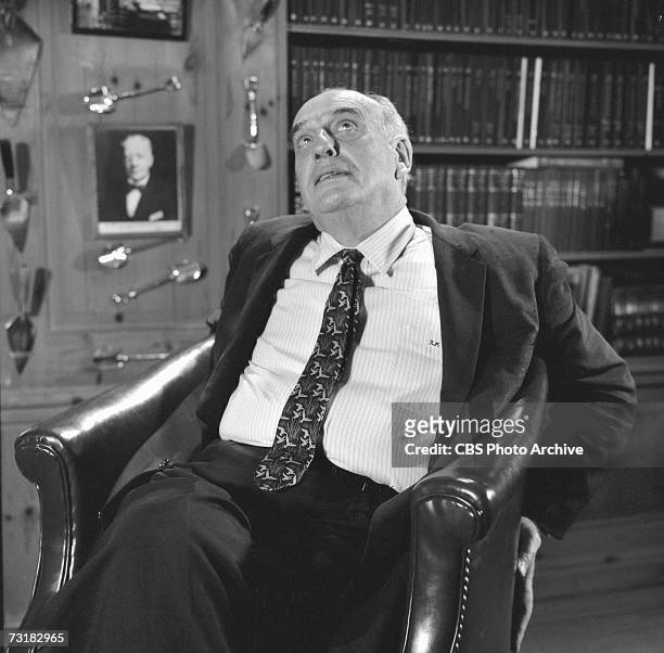 American public official and city planner Robert Moses sits in his office during an interview for 'The Twentieth Century,' a television documentary...