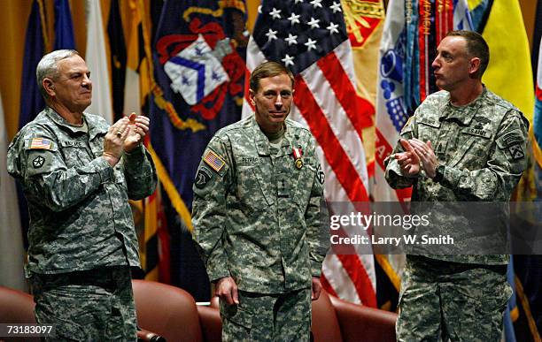 Lieutenant General David H. Petraeus is applauded by General William S. Wallace and Commander Sgt. David Bruner right and the audience during a...