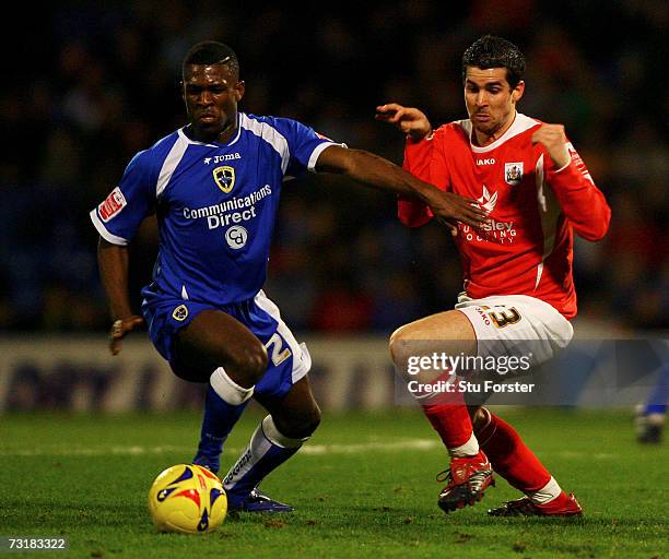 Barnsley striker Daniel Nardiello battles with Cardiff defender Kerrea Gilbert during the Coca Cola Championship game between Cardiff City and...
