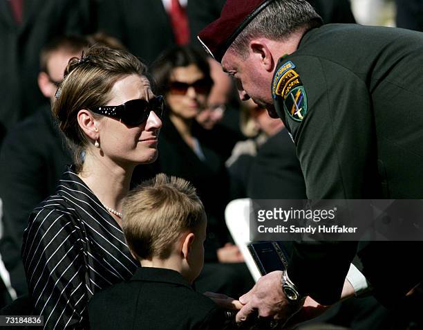 General David Morris presents Charlotte Freeman with her husband's Purple Heart award during a memorial service at Ft. Rosecrans National Cemetery on...