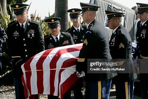 Military Honor Guard members carry a coffing with Capt. Brian Freeman during a memorial service at Ft. Rosecrans National Cemetery on February 2,...