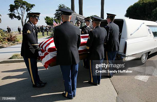 Military Honor Guard members take out the coffin with Capt. Brian Freeman during a memorial service at Ft. Rosecrans National Cemetery on February 2,...