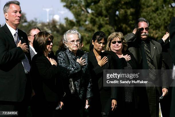 Friends and family cross their hearts during a prayer at the funeral of Captain Brian Freeman during a memorial service at Ft. Rosecrans National...