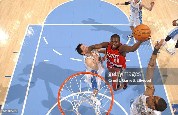 Zach Randolph of the Portland Trail Blazers goes to the basket against Eduardo Najera and Marcus Camby of the Denver Nuggets at the Pepsi Center...