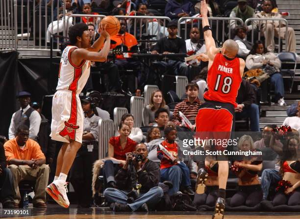 Josh Childress of the Atlanta Hawks takes a shot against Anthony Parker of the Toronto Raptors at Philips Arena on February 2, 2007 in Atlanta,...