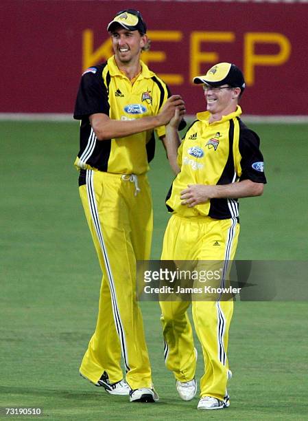 Chris Rogers and Brett Dorey of the Warriors celebrates after dismissing Mark Cosgrove of the Redbacks during the Ford Ranger Cup match between the...