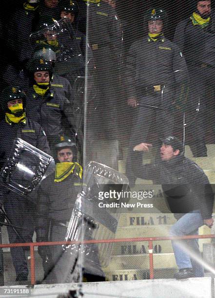 Rival fans turn on each other and police officers during the Serie A match between Palermo and Catania Calcio at Stadio Angelo Massimino February 2,...