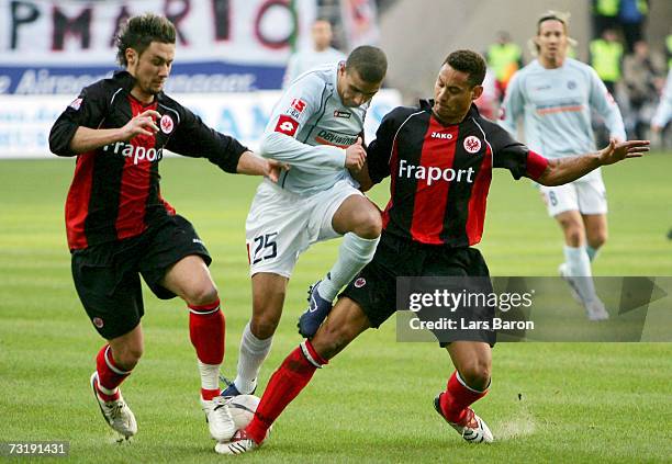 Albert Steit and Jermaine Jones of Frankfurt in action with Mohamed Zidan of Mainz during the Bundesliga match between Eintracht Frankfurt and FSV...