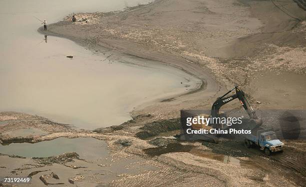 Dredger excavates sand at river beach of Yangtze River February 3, 2007 in Chongqing Municipality, China. According to local media, large amount of...