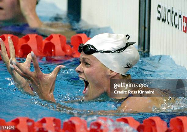 Inge de Bruijn of Holland celebrates winning the gold medal in a world record time of 56.61 in the Women's 100m Butterfly final during the Sydney...
