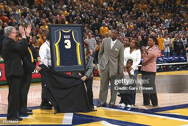 Dwyane Wade of the Miami Heat along with son Zaire, wife Siohvaughn, and Darlene watch as his jersey is unvieled in a ceremony to retire his...