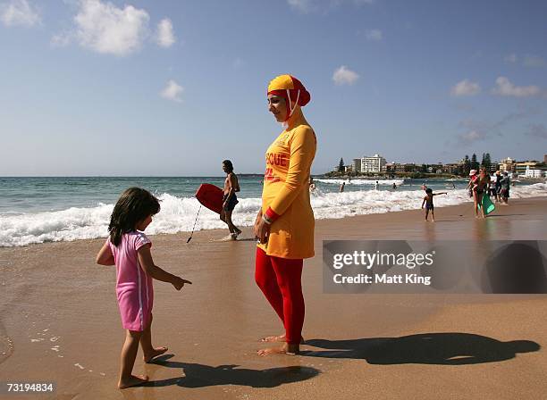 Mecca Laa Laa talks to a young girl whilst wearing a 'Burqini' on her first surf lifesaving patrol at North Cronulla Beach February 4, 2007 in...