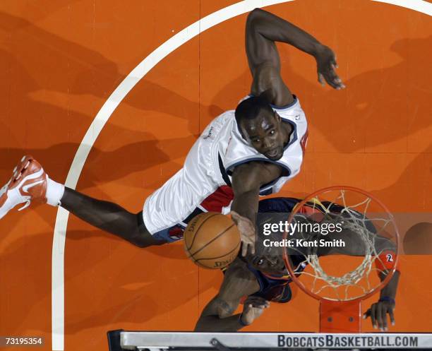 Emeka Okafor of the Charlotte Bobcats shoots over Mickael Pietrus of the Golden State Warriors on February 3, 2007 at the Charlotte Bobcats Arena in...