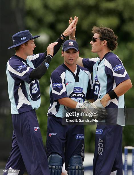 Martin Guptill , Reece Young and Rob Nicol of Auckland celebrate the wicket of Gareth Hopkins of Otago during the Twenty20 Final match between State...