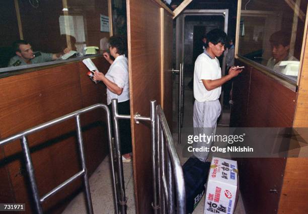 Chinese citizens arrive at the passport control center August 31, 2000 in the village of Pogranichyi, 250 km South-East of Vladivostok, at the...