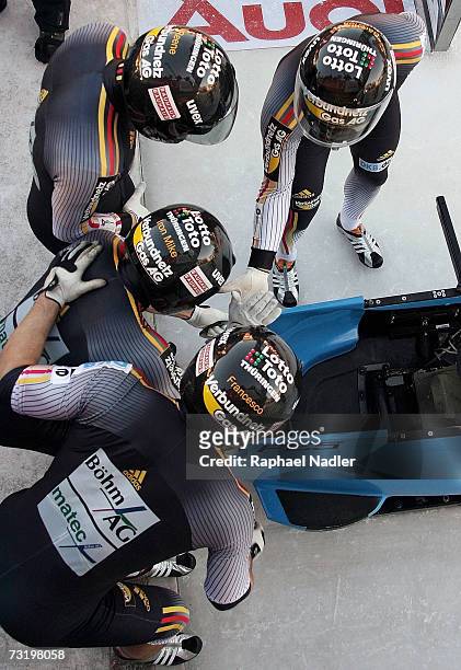 Andre Lange, Rene Hoppe, Kevin Kuske and Martin Putzeduring of Germany give a high five prior to the start of the Four Man Bobsleigh event at the...