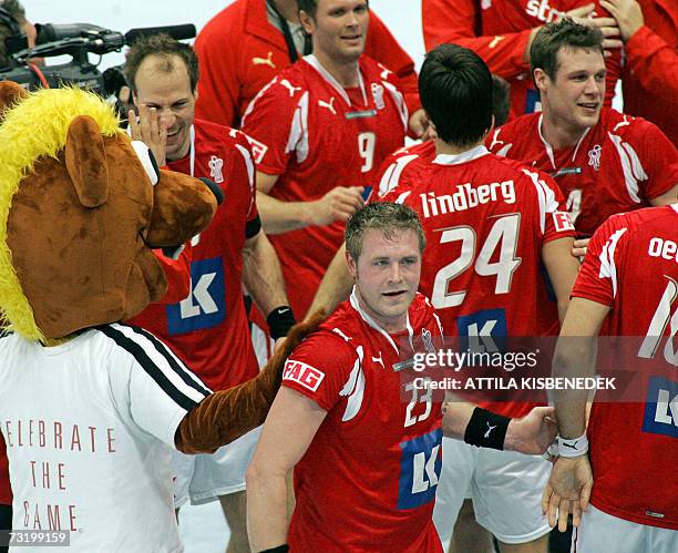 The mascot of the world championships Hanniball congratulates the Danish players, for their victory over France in the match for 3th place of the...