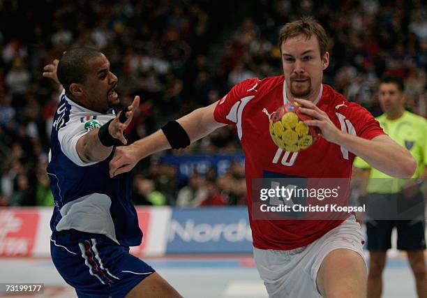 Didier Dinart of France gets past Lars Moeller Madsen of Denmark during the IHF World Championship third place game between France and Denmark at the...