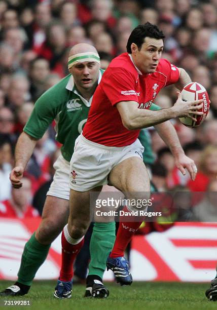 Stephen Jones of Wales is pursued by John Hayes of Ireland during the RBS Six Nations Championship match between Wales and Ireland at the Millennium...