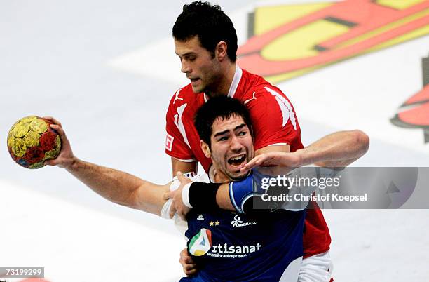 Nikola Karabatic of France is attacked by Michael Knudsen of Denmark during the IHF World Championship third place game between France and Denmark at...