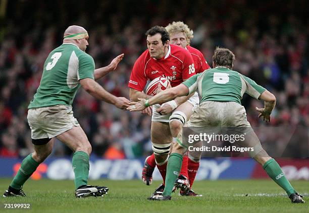 Robert Sidoli of Wales is tackled by John Hayes and Simon Easterby during the RBS Six Nations Championship match between Wales and Ireland at the...