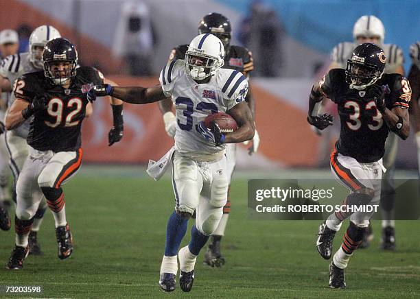 Running back Dominic Rhodes of the Indianapolis Colts outruns Hunter Hillenmeyer and Charles Tillman of the Chicago Bears 04 February 2007 during...