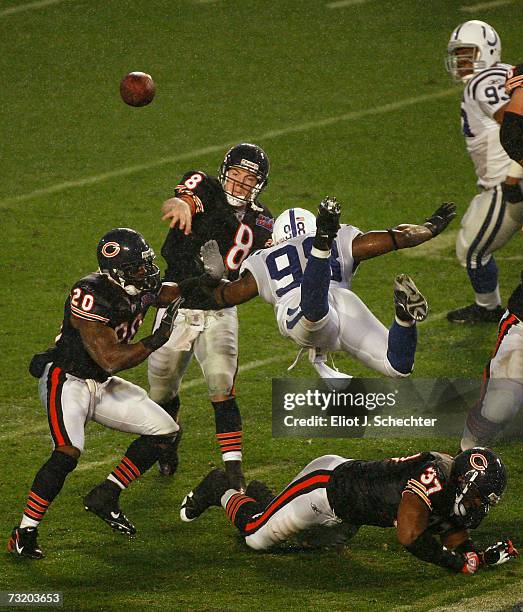 Rex Grossman of the Chicago Bears throws a pass under pressure from Robert Mathis of the Indianapolis Colts during Super Bowl XLI on February 4, 2007...