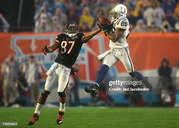 Cornerback Kelvin Hayden of the Indianapolis Colts catches an interception over Muhsin Muhammad of the Chicago Bears before returning for a 56-yard...