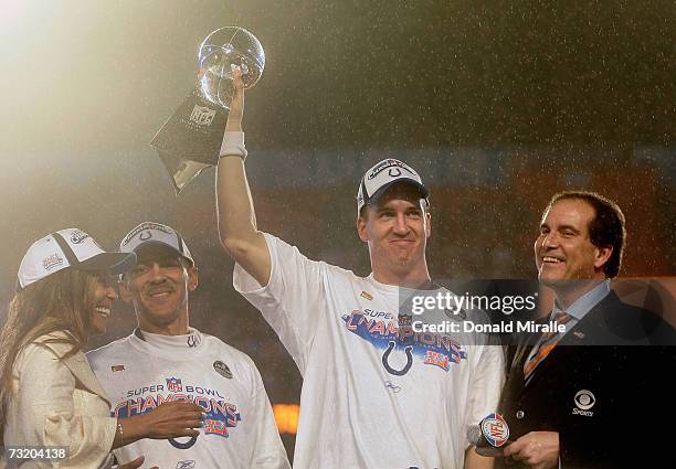 Quarterback Peyton Manning of the Indianapolis Colts celebrates with the Vince Lombardi Super Bowl trophy next to head coach Tony Dungy and is wife,...