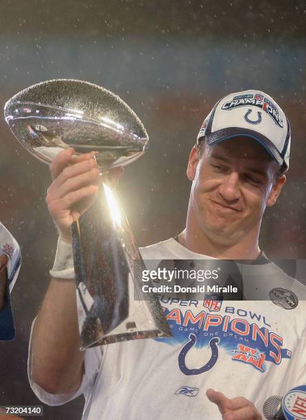 Quarterback Peyton Manning of the Indianapolis Colts smiles as he holds the Vince Lombardi Super Bowl trophy after his team won the Super Bowl XLI...