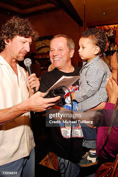 Chef Wolfgang Puck is interviewed for The Howard Stern Show as son Oliver looks on at the Super Bowl Bash at Spago at Wolfgang Puck's Spago...