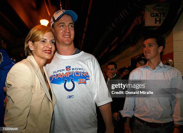 Quarterback Peyton Manning of the Indianapolis Colts poses for a photo with his mother Olivia Williams Manning while brother Cooper looks on after...